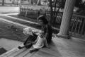Photograph: [Photograph of a woman and a baby on a porch]