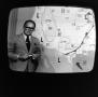 Photograph: [A weatherman on television]