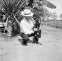 Photograph: [Photograph of Albert Stiles with a dog]