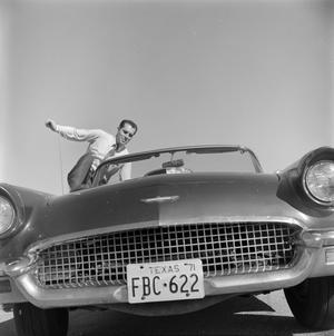 Primary view of object titled '[Ward Andrews hopping into a T-Bird]'.