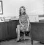 Photograph: [Diana Miller sitting in an office]