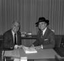 Photograph: [Photograph of two men sitting at a table together]