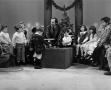 Primary view of [Photograph of Bill Kelley sitting among many children at a KXAS Christmas Children's Hour party]