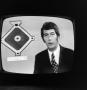 Photograph: [A sports reporter on television]