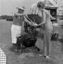 Photograph: [Man serving a woman food at a barbecue]