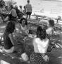Photograph: [Women sitting at a picnic table]