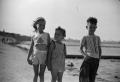 Photograph: [Photograph of Carol and Tim Williams and a friend at the beach]