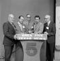 Photograph: [Five men behind a WBAP podium]