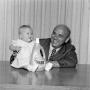 Photograph: [A man holding a baby]