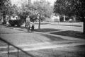 Photograph: [Photograph of a man and a young boy in a neighborhood]