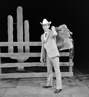 Primary view of object titled '[Kelley carrying a saddle]'.