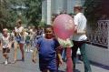 Photograph: [A young boy holding a balloon at Six Flags]