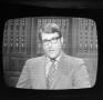 Photograph: [Man appearing on a television screen]