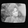 Photograph: [Woman on a television screen]
