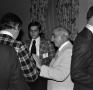 Photograph: [Photograph of a group of individuals socializing at an event]