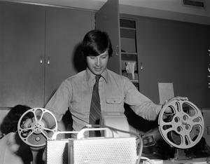 Primary view of object titled '[Henry de La Garza with film reels]'.
