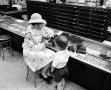 Photograph: [A women and a child at a store]
