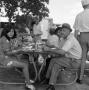 Photograph: [A family eating at a picnic]