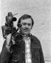 Photograph: [Photograph of David Young posing with a camera]