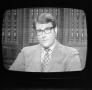 Photograph: [Man with glasses on a television screen]