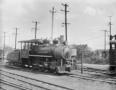 Primary view of [Photograph of a locomotive on the tracks]