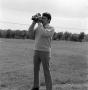 Photograph: [Ron Spain using a camera outside]