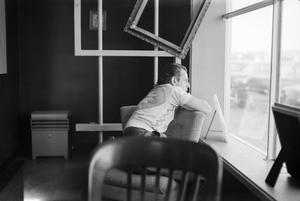 Primary view of object titled '[Photograph of Charles Williams looking out a window]'.