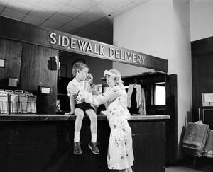 Primary view of object titled '[Woman and a child at an establishment, 4]'.