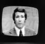 Photograph: [Ken McCool on a television screen]