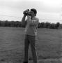Photograph: [Ron Spain holding a camera]