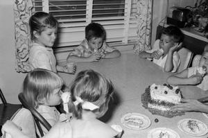 Primary view of object titled '[Pam, Byrd IV, and friends eating ice cream at their birthday party]'.