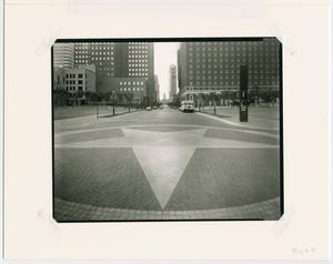 Black and white photo of a huge walkway, a star in a circle painted on it.
