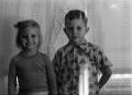 Photograph: [Photograph of Carol and Tim Williams in front of a window, 2]