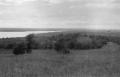 Photograph: [Photograph of a field and a body of water]