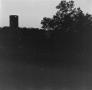 Photograph: [Photograph of a silo standing among trees]