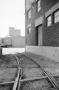 Primary view of [Photograph of train tracks running near a building]