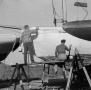 Photograph: [Photograph of two individuals painting a boat, 2]