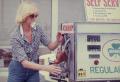 Photograph: [Woman pumping gas]