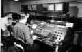 Photograph: [Men in control booth]