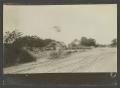 Photograph: [Dirt road and a small farm]