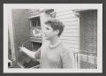 Photograph: [Photograph of Byrd Williams V flying a kite on a balcony]