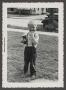 Photograph: [A little boy standing outside]