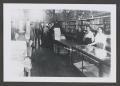 Photograph: [Photograph of individuals standing in a store]