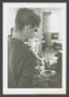 Photograph: [Photograph of a woman preparing a plate of food, 2]