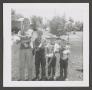 Photograph: [Byrd IV, Johnny, Michael, and Brad holding cats]