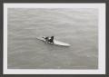 Photograph: [Photograph of a teenage boy on a surfboard]