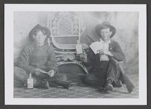 Primary view of object titled '[Photograph of two men posing with guns and liquor bottles]'.