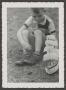 Photograph: [Photograph of Tim Williams playing with a toy boat, 5]