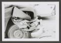 Photograph: [Photograph of the front end of a wrecked automobile]