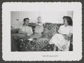 Photograph: [Photograph of baby Pam Williams with a man and a woman]